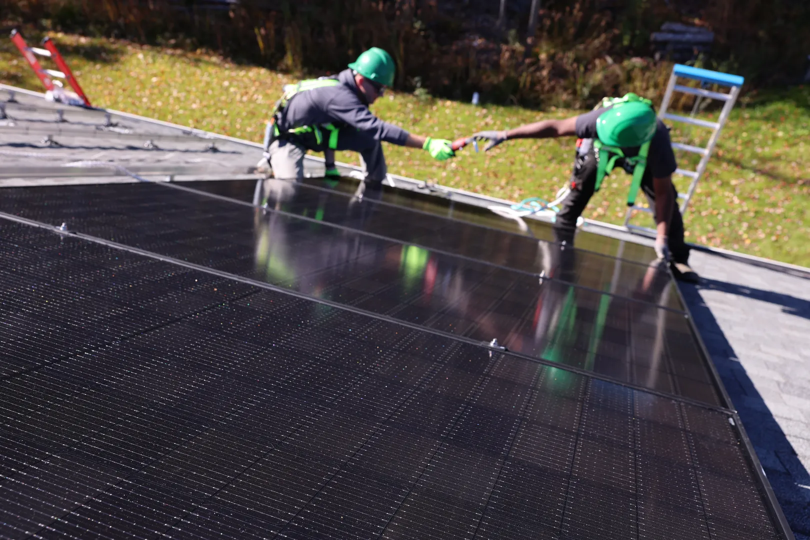 Solar panel installation crew working on rooftop