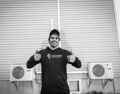 Greenfoot technician showing pride in professional heat pump installation